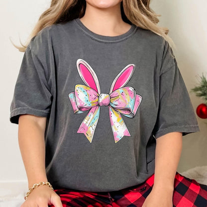 May include: A gray t-shirt with a pink and white bow with bunny ears on it.