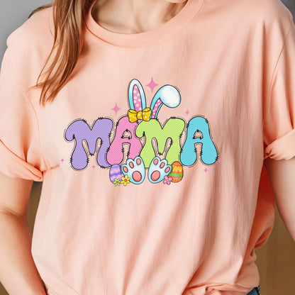 May include: A pink t-shirt with a colorful graphic of the word "MAMA" with bunny ears and Easter eggs. 