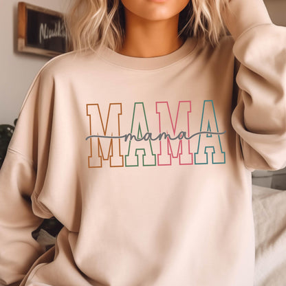 May include: A beige sweatshirt with the word "MAMA" printed in colorful block letters with a handwritten "mama" underneath.