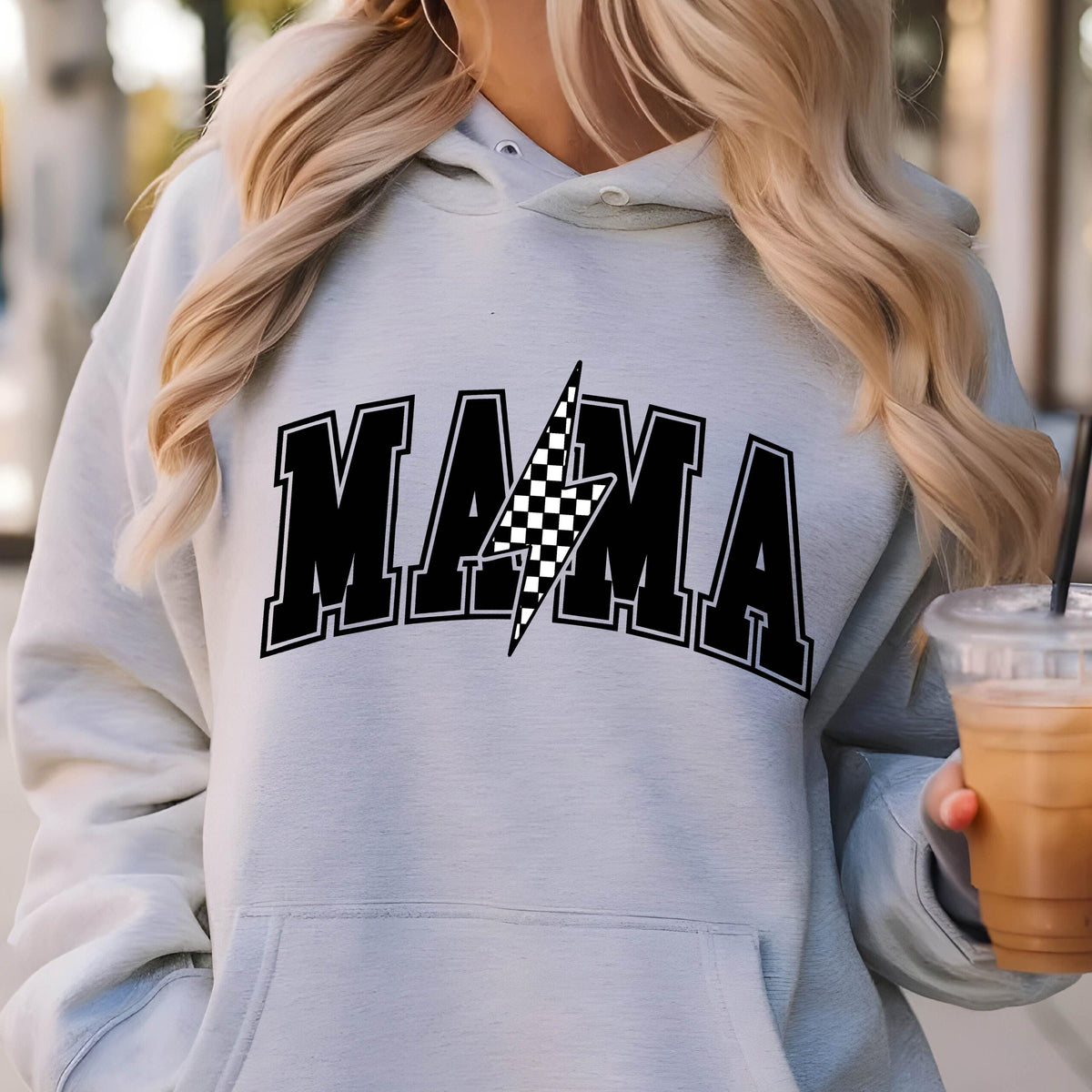 May include: A gray hoodie with a black and white checkered lightning bolt graphic and the word "MAMA" in black block letters.