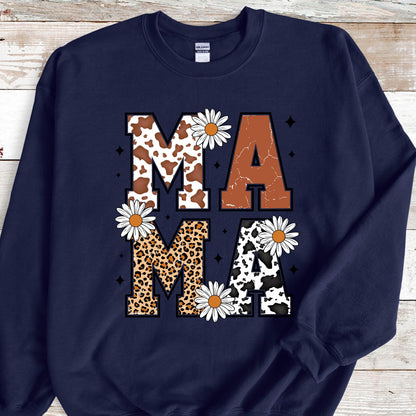 May include: Navy blue sweatshirt with the word "MAMA" in large, white letters. Each letter is decorated with a different animal print: cowhide, brown, leopard, and cowhide. The letters are surrounded by white daisies.