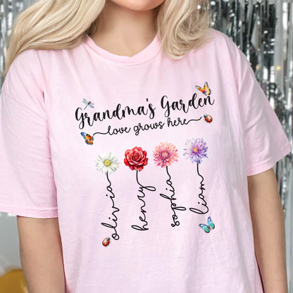 May include: Pink t-shirt with the text "Grandma's Garden - love grows here" and four flowers with names Olivia, Henry, Sophia, and Liam written underneath.