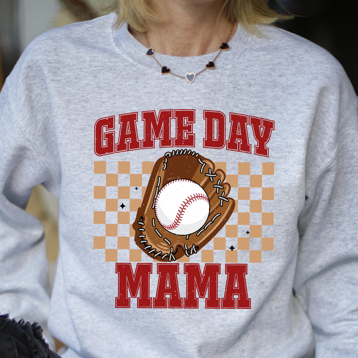 May include: Gray sweatshirt with the text "GAME DAY MAMA" in red letters. A baseball and glove are in the center of the text, with a checkered background.