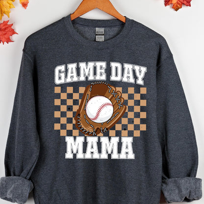 May include: A dark gray sweatshirt with the text "GAME DAY MAMA" in white. A brown baseball glove with a white baseball is in the center of the text. A checkered pattern is behind the glove.