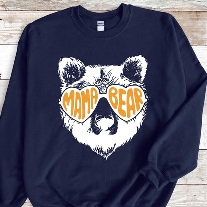 May include: Navy blue sweatshirt with a white bear wearing orange heart-shaped sunglasses that say "Mama Bear".