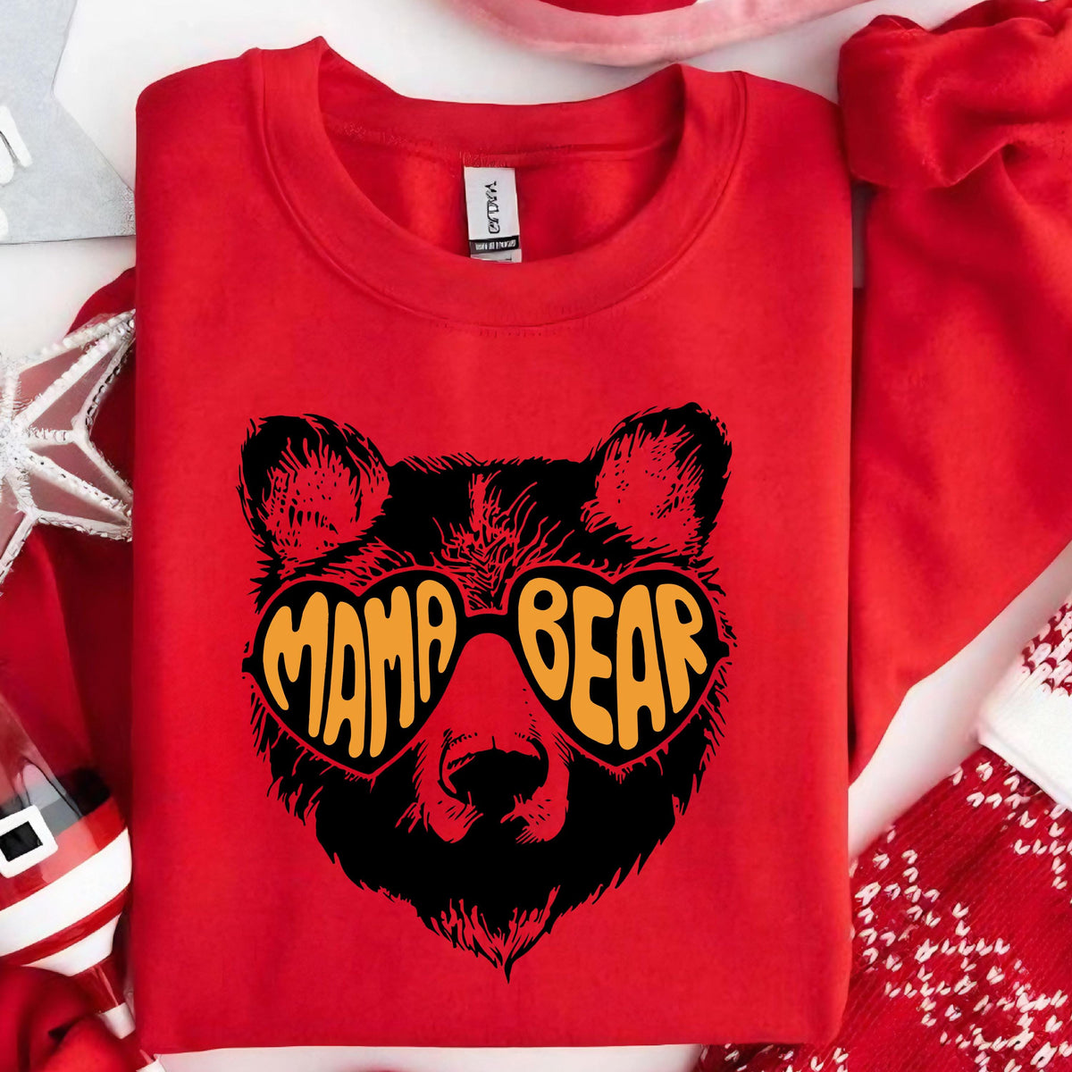 May include: Red sweatshirt with a black bear wearing heart-shaped sunglasses that say "Mama Bear" in orange letters.