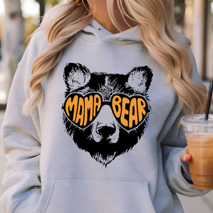 May include: Gray hooded sweatshirt with a black bear wearing heart-shaped sunglasses that say "Mama Bear" in orange letters.