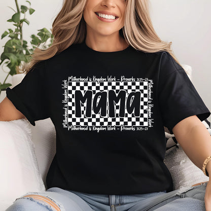 May include: Black t-shirt with a white checkered background and the word "Mama" in bold white letters. The text "Motherhood is Kingdom Work - Proverbs 31:25-27" is written in white on the top and bottom of the checkered background.
