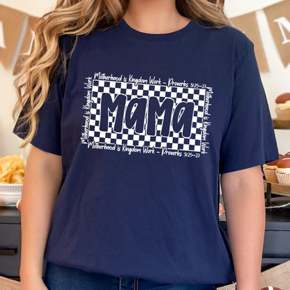 May include: Navy blue t-shirt with a white checkered design and the word "Mama" in bold white letters. The text "Motherhood is Kingdom Work - Proverbs 3:25-27" is written in white around the checkered design.