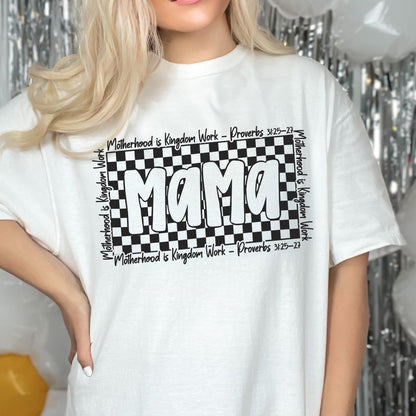 May include: White t-shirt with a black and white checkered design and the word "Mama" in large, white letters. The text "Motherhood is Kingdom Work - Proverbs 3:25-27" is repeated around the checkered design.