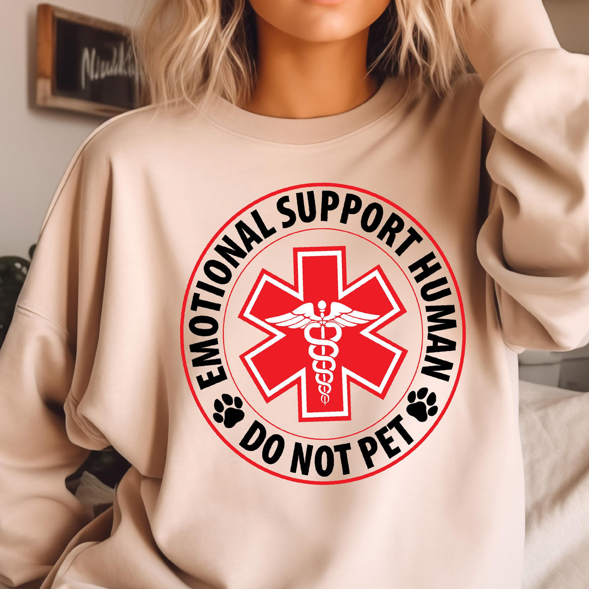 May include: A beige sweatshirt with a red medical symbol and the text "Emotional Support Human Do Not Pet" in a black circle.