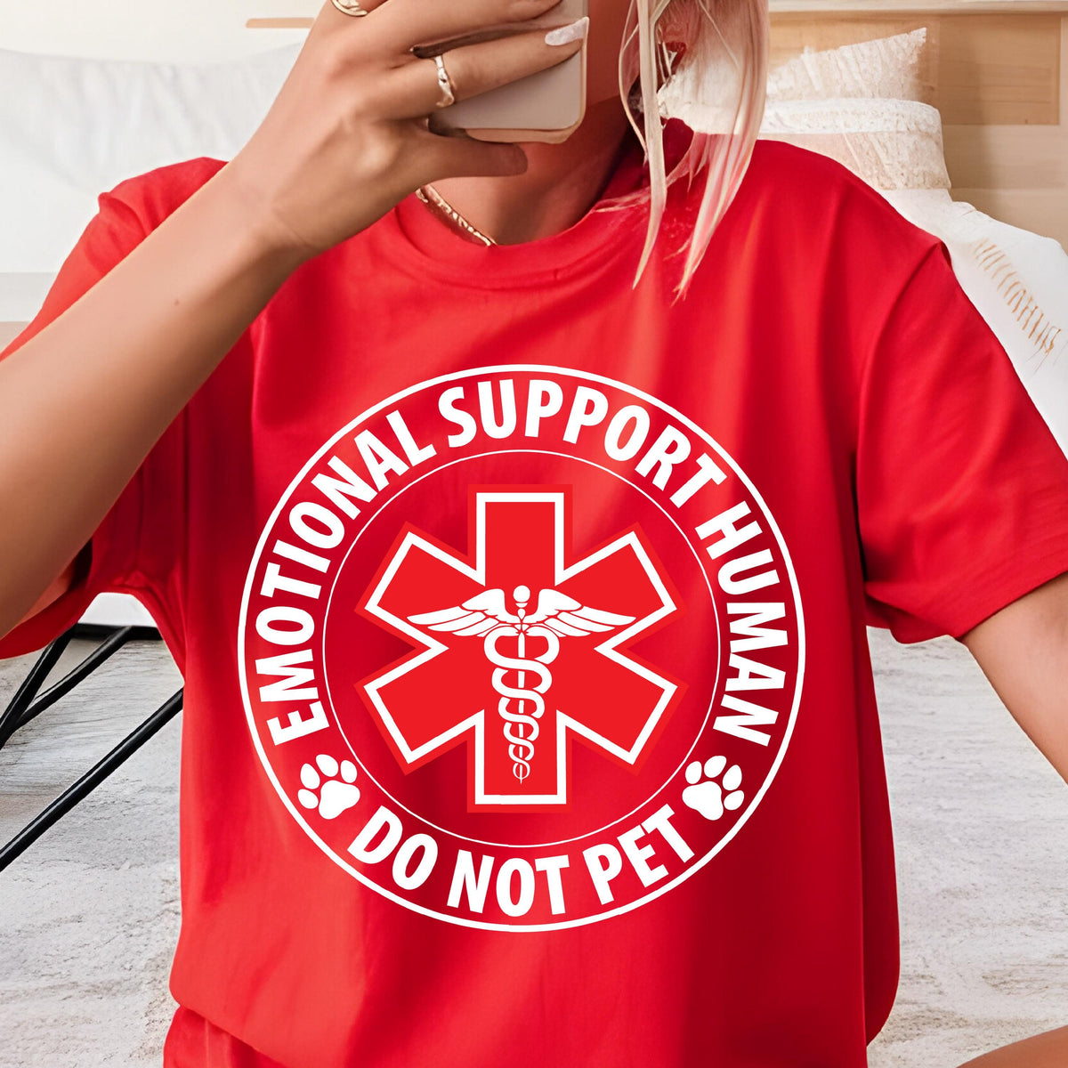 May include: Red t-shirt with a white circle graphic that says "Emotional Support Human Do Not Pet" with a red medical symbol in the center.