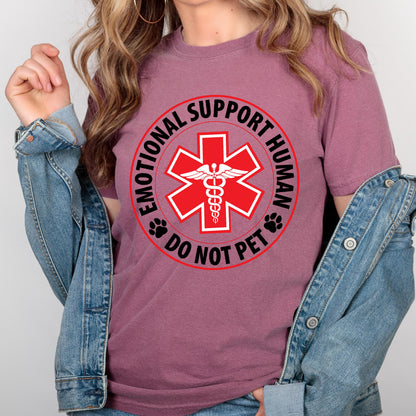 May include: A maroon t-shirt with a black and white graphic of a red medical star with a snake and wings inside. The graphic is surrounded by a black circle with the text "Emotional Support Human Do Not Pet" in white.