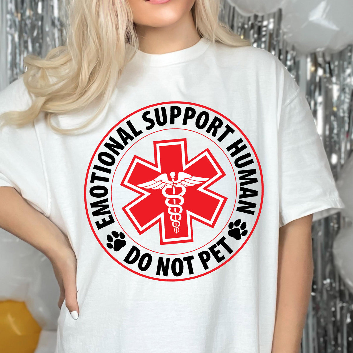May include: White t-shirt with a black and red circle graphic that says "Emotional Support Human Do Not Pet". The graphic features a red medical symbol with a snake and wings.