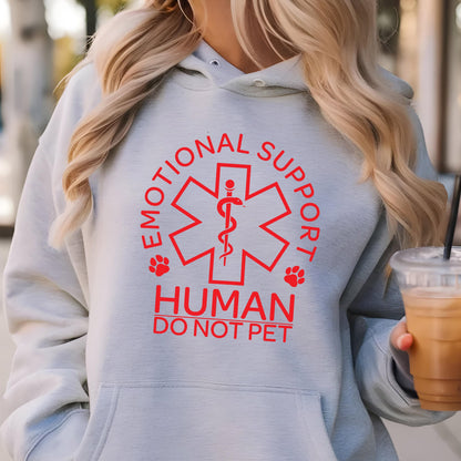 May include: A light gray hoodie with a red graphic that says "Emotional Support Human Do Not Pet". The graphic features a red star of life with a snake and a caduceus.