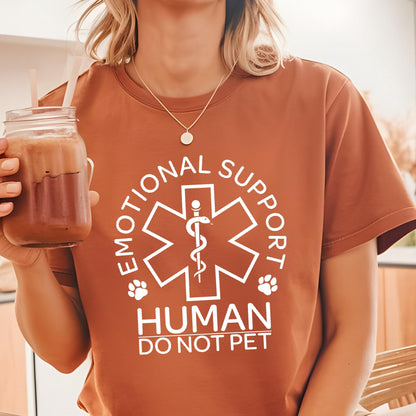 May include: A rust-colored short-sleeve t-shirt featuring a white graphic of a Star of Life symbol with a snake and staff, surrounded by the text "EMOTIONAL SUPPORT HUMAN DO NOT PET" and two small paw prints on the sides of the central emblem.