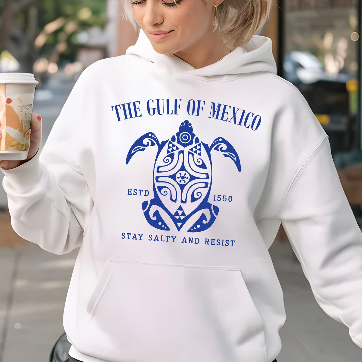 May include: White hoodie with a blue graphic of a turtle with the text "The Gulf of Mexico" above it, "Est. 1550" below the turtle, and "Stay Salty and Resist" below the date.