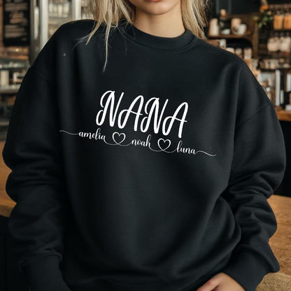 May include: Black sweatshirt with the word "NANA" in white cursive lettering. Below the word "NANA" are the names "amelia", "noah", and "luna" with a heart symbol between each name.