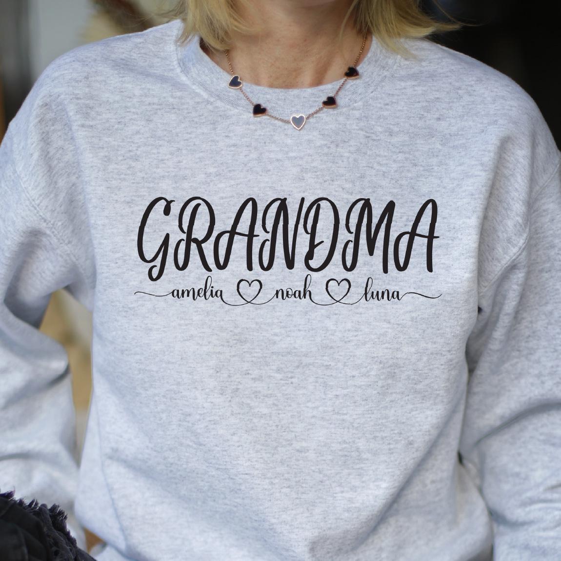 May include: Gray sweatshirt with the text "Grandma" in black cursive lettering. Below the text are three hearts with the names "Amelia", "Noah", and "Luna" written in black.