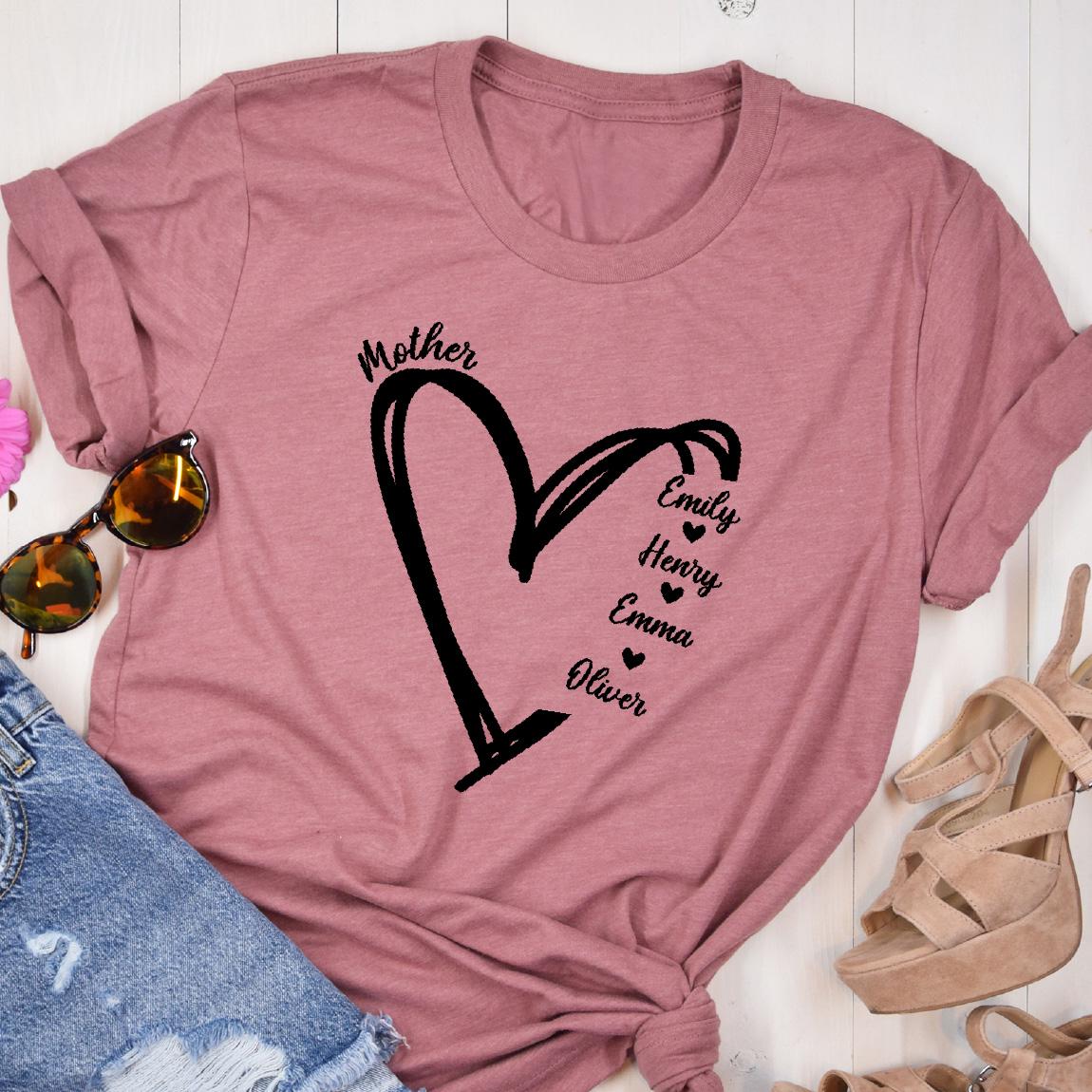 May include: A pink t-shirt with a black heart design and the word "Mother" above it. Inside the heart are the names "Emily", "Henry", "Emma", and "Oliver" with a small heart symbol next to each name.