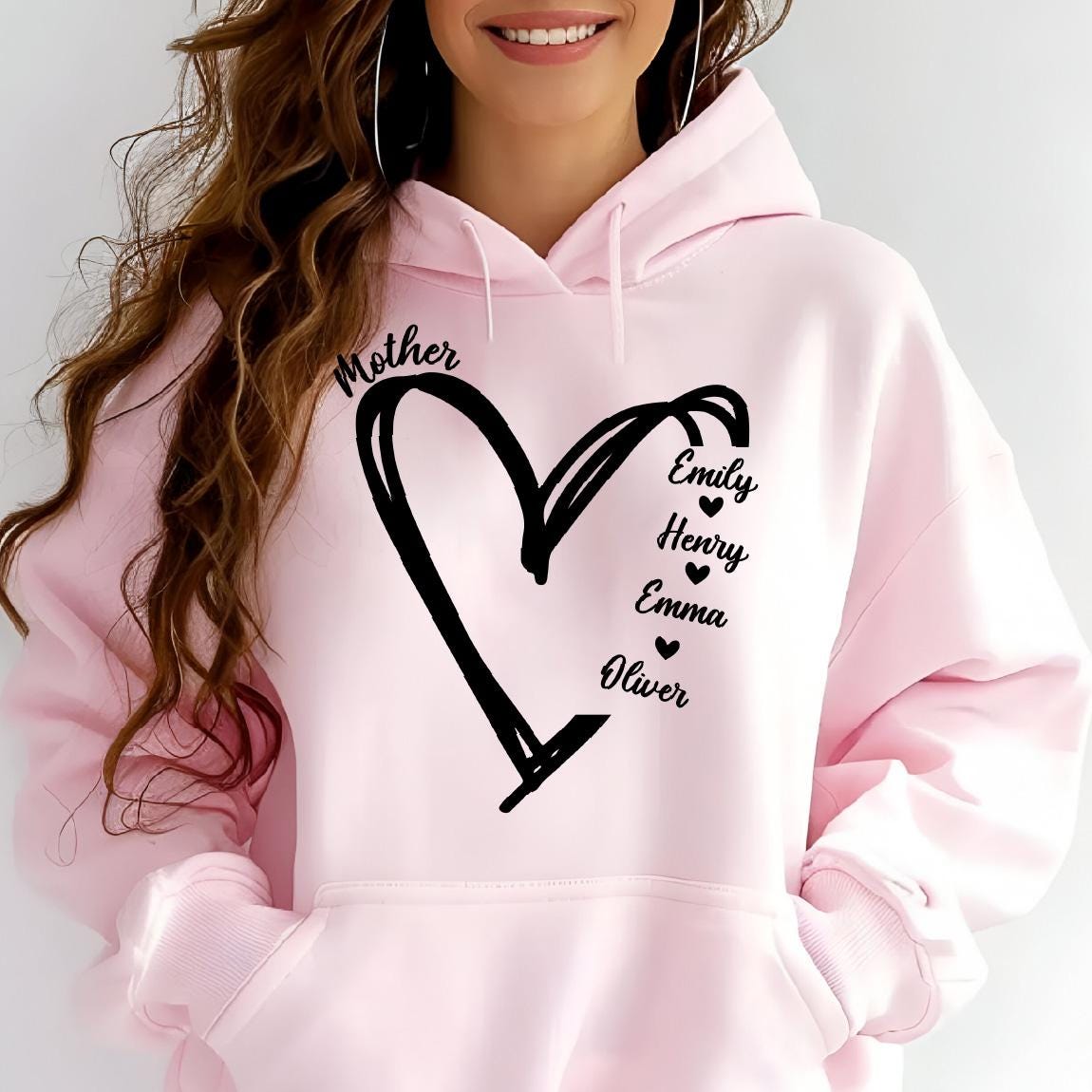 May include: Pink hoodie with a black heart design and the word "Mother" above it. The names Emily, Henry, Emma, and Oliver are listed inside the heart.