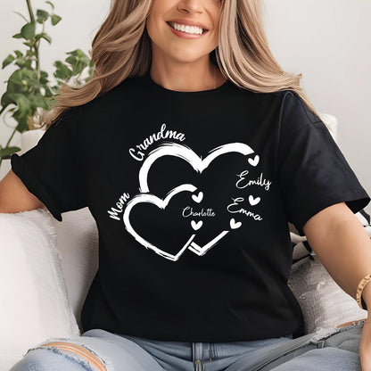 May include: Black t-shirt with a white design of two interlocking hearts. The hearts have the words "Grandma", "Mom", "Charlotte", "Emily", and "Emma" written on them.