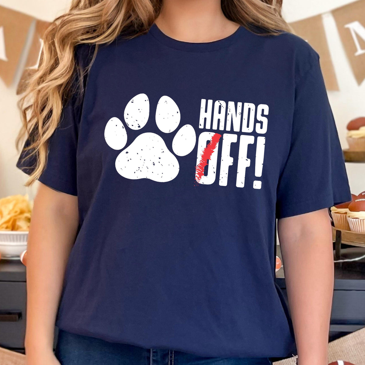 May include: A navy blue t-shirt with a white paw print and the text "HANDS OFF!" in white with a red slash through the "O".