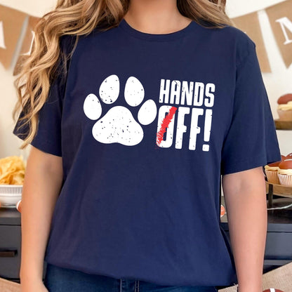 May include: A navy blue t-shirt with a white paw print and the text "HANDS OFF!" in white with a red slash through the "O".