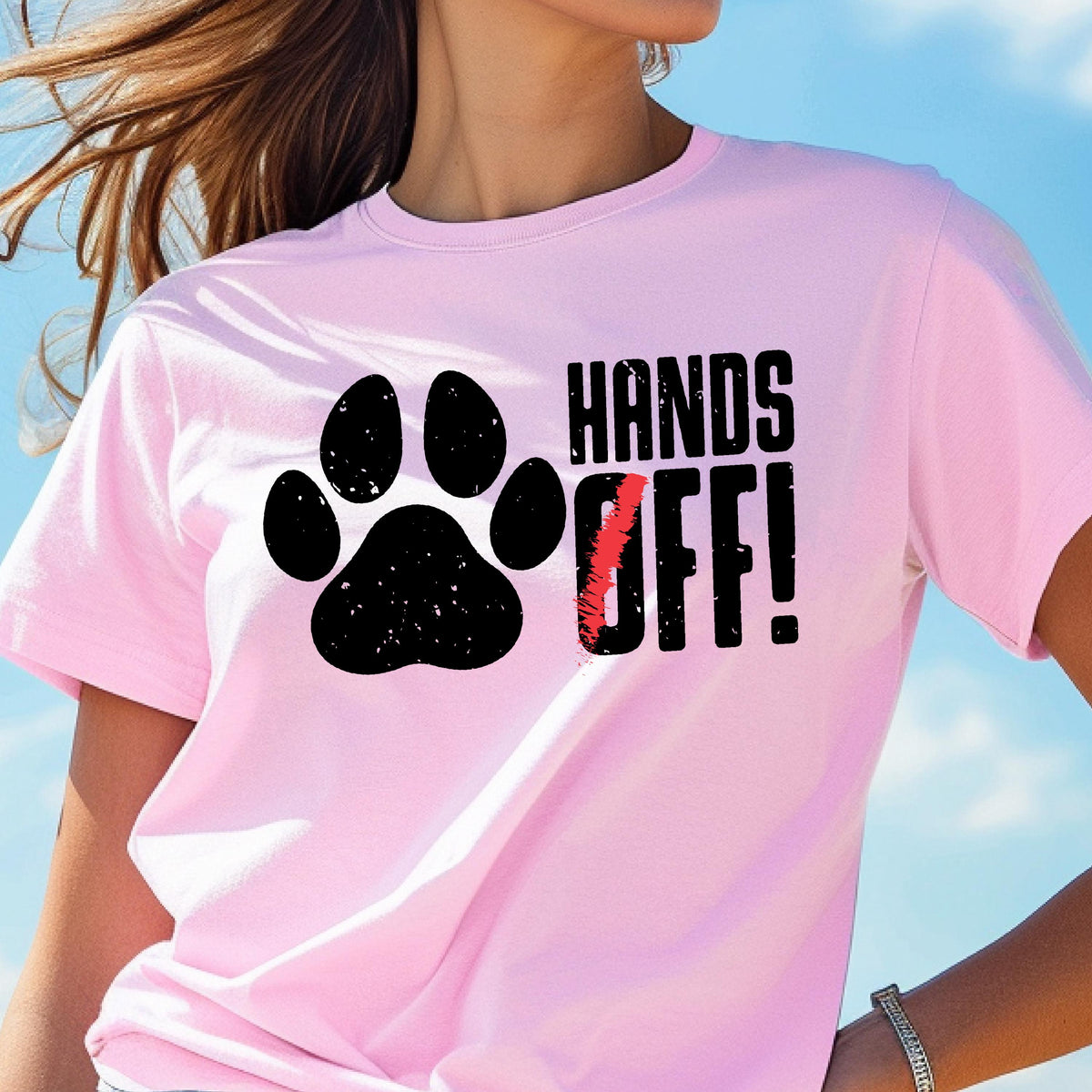 May include: Pink t-shirt with a black paw print and the text "Hands Off!" in black.