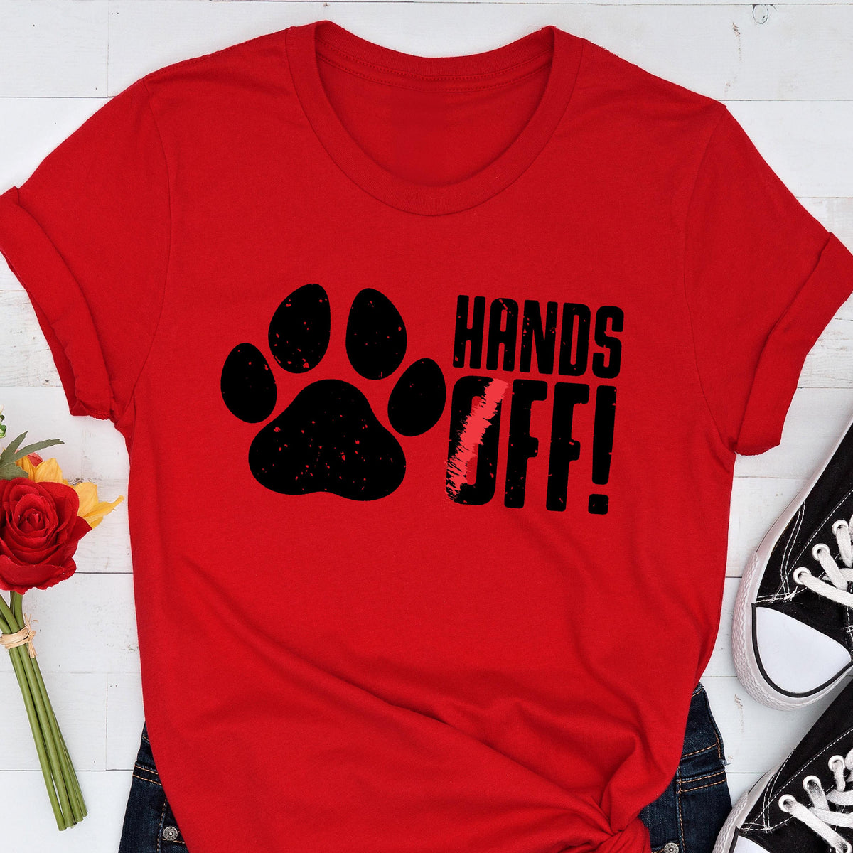 May include: Red t-shirt with a black paw print and the text "HANDS OFF!" in black.