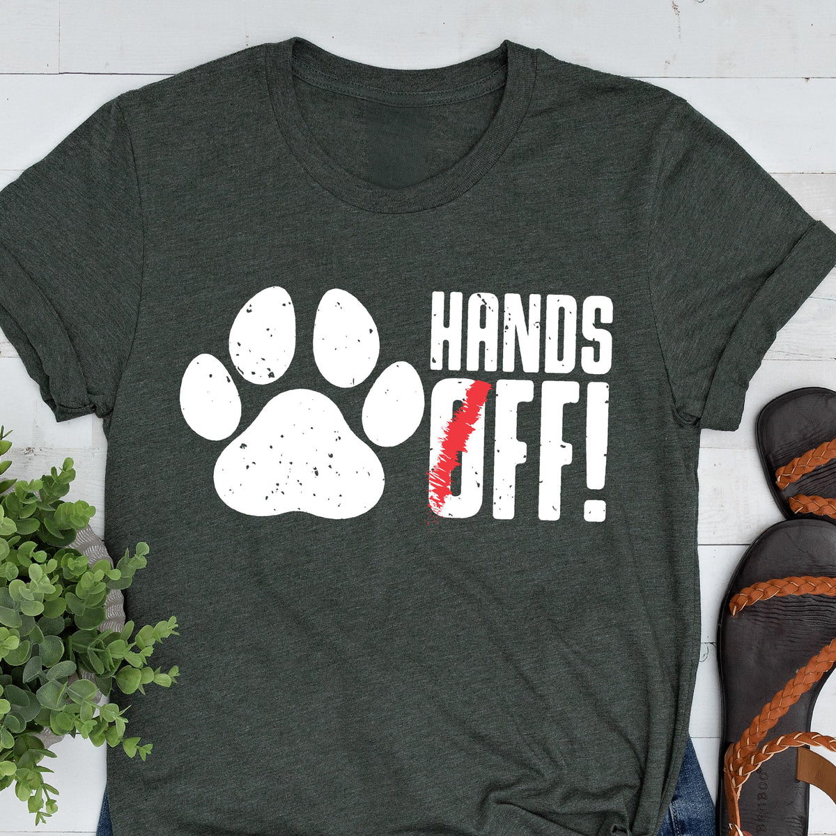 May include: A dark green t-shirt with a white paw print and the text "Hands Off!" in white letters.