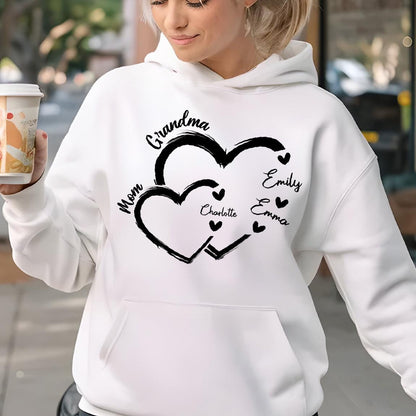 May include: White hoodie with a black design of two intertwined hearts. The hearts have the words "Grandma", "Mom", "Charlotte", "Emily", and "Emma" written on them.