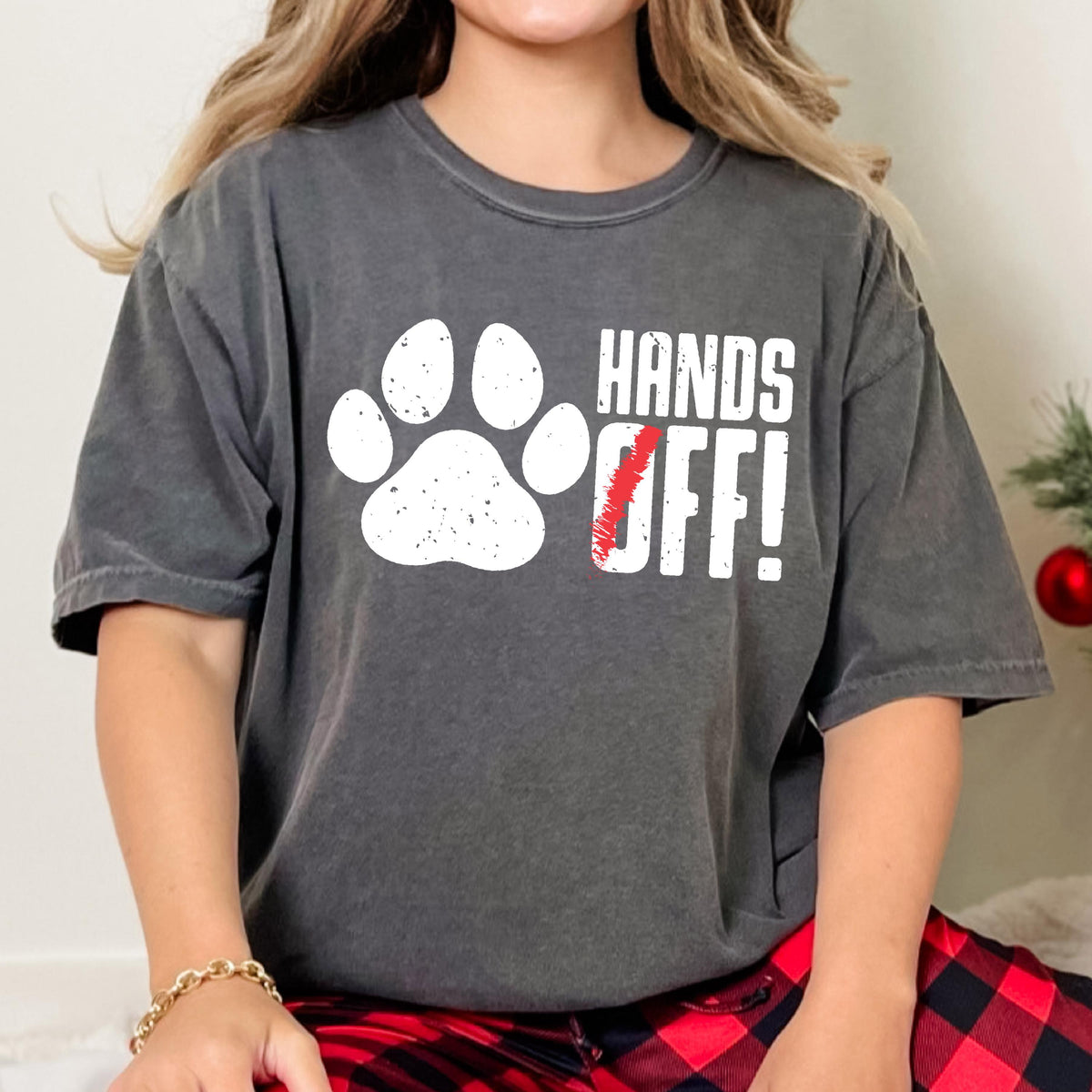 May include: A gray t-shirt with a white paw print and the text "HANDS OFF!" in white letters. The "O" in "OFF" is crossed out with a red line.