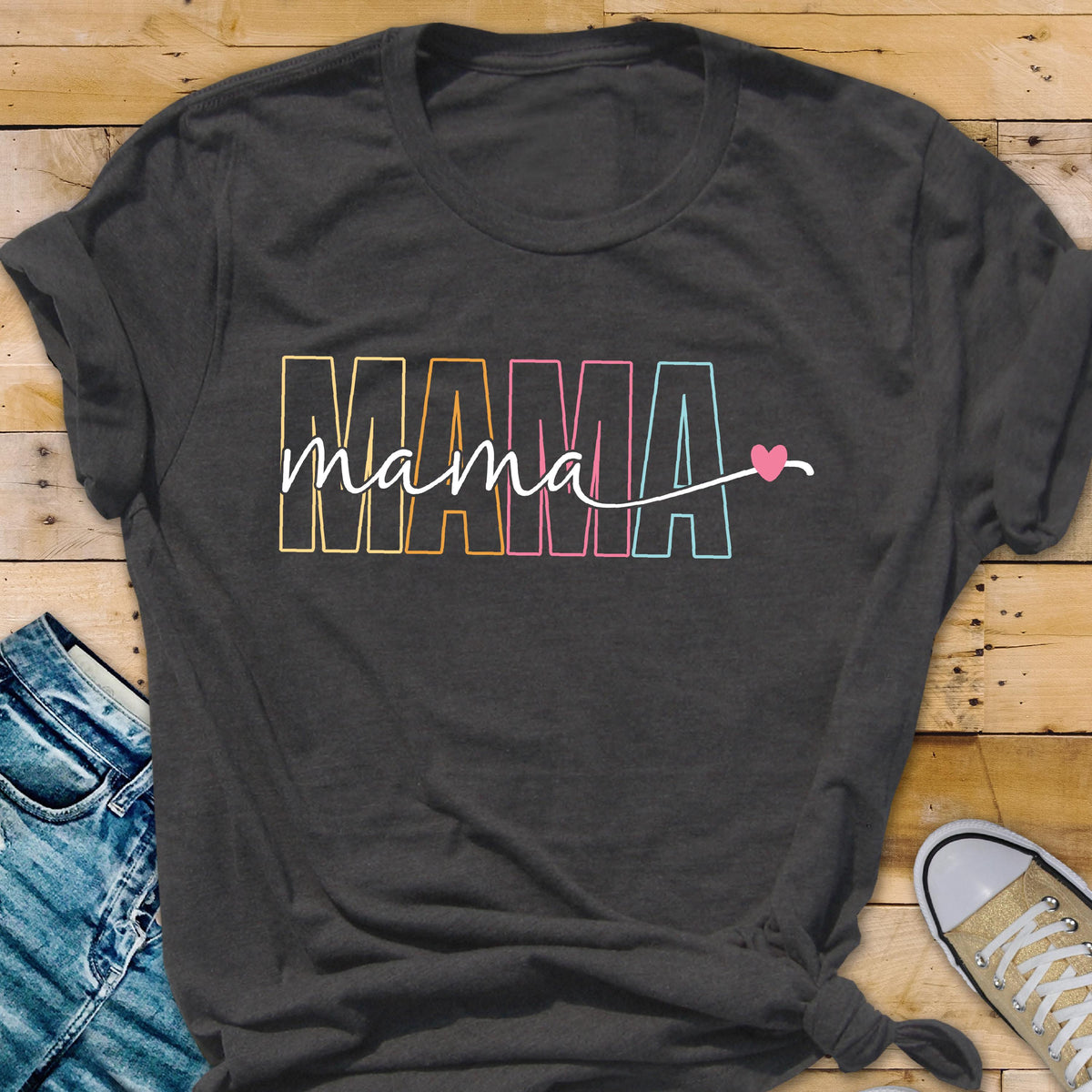 May include: A dark gray t-shirt with the word "MAMA" in rainbow colors and a small pink heart.