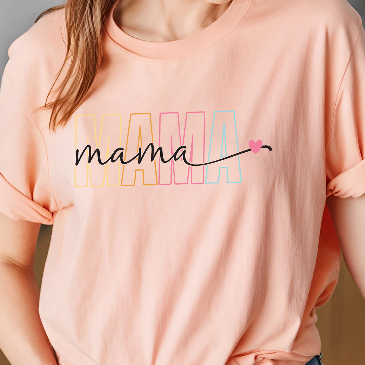 May include: A pink t-shirt with the word "mama" in rainbow colors and a small pink heart.
