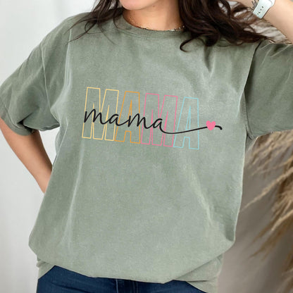 May include: A green t-shirt with the word "mama" written in black script with a rainbow colored "MAMA" behind it and a small pink heart.