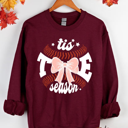 May include: Burgundy sweatshirt with a white baseball graphic and the text "tis the season" with a pink bow in the center.
