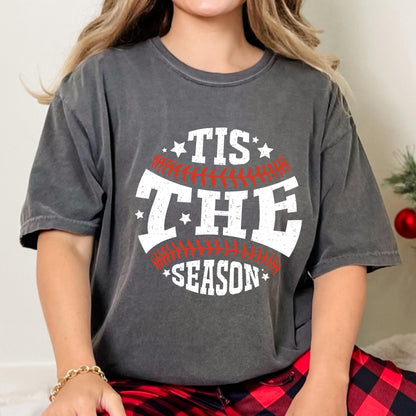 May include: A gray t-shirt with a white baseball graphic and the text "Tis the Season" in red.