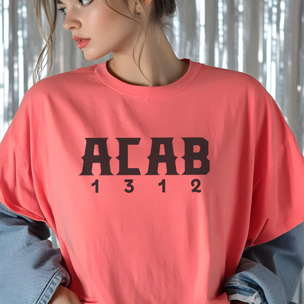 May include: A coral-colored short-sleeve t-shirt featuring the black text ACAB in a bold, stylized font across the chest, with the numbers 1 3 1 2 printed in a smaller, simple black font directly underneath the letters.