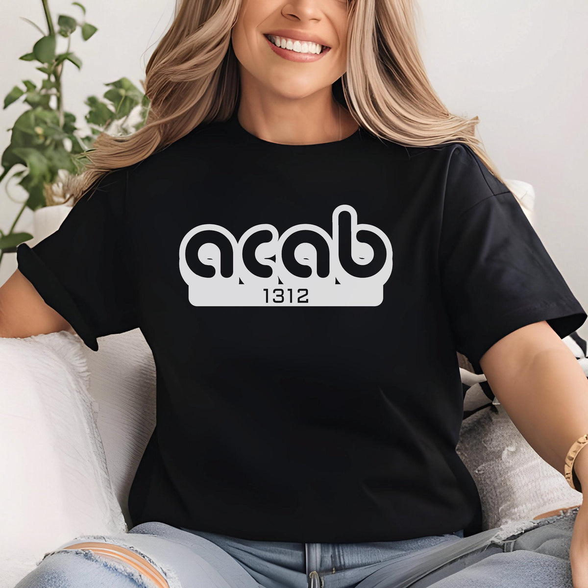 May include: Black t-shirt with a white graphic of the text "acab" in a rounded font with the number "1312" underneath.