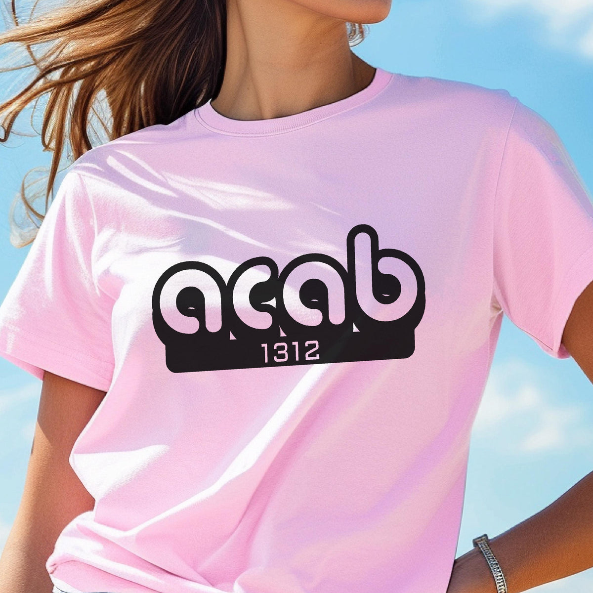 May include: Pink t-shirt with a black graphic that says "ACAB" with the number "1312" underneath.