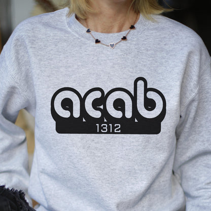 May include: A gray sweatshirt with a black graphic print of the text "ACAB" in a stylized font with the number "1312" underneath.