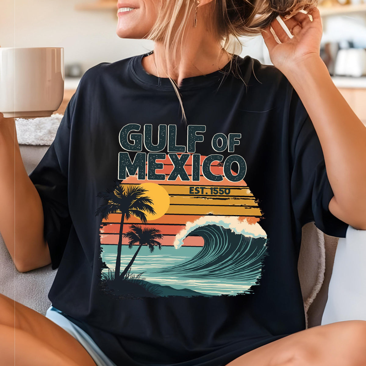 May include: Black t-shirt with a retro-style graphic of a wave crashing on a beach with palm trees and the text "GULF OF MEXICO EST. 1550".