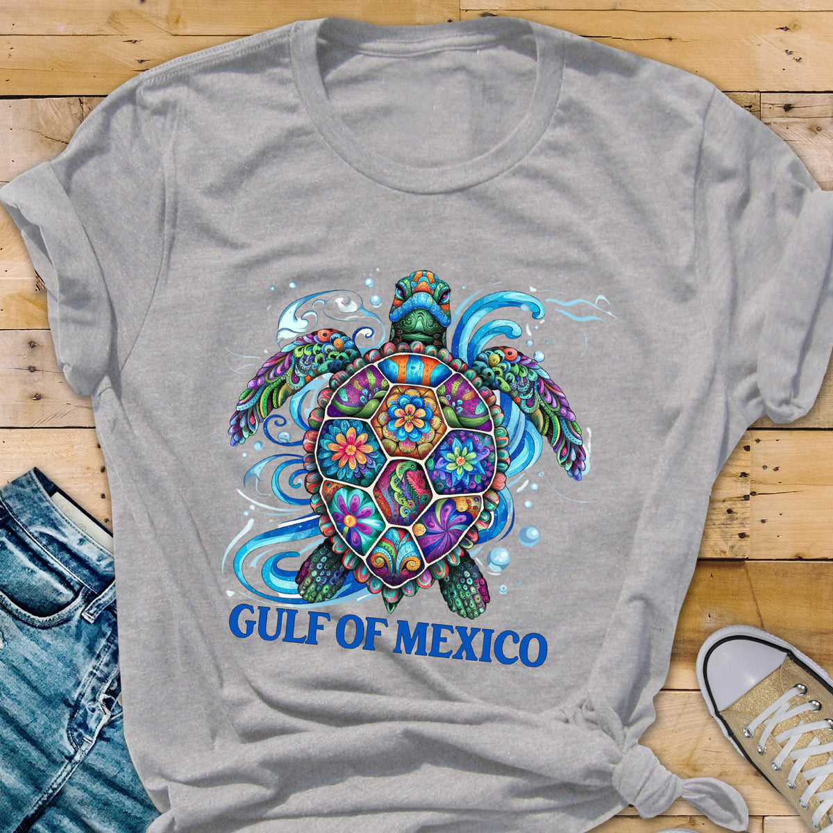 May include: Gray t-shirt with a colorful, patterned sea turtle design and the text "GULF OF MEXICO" in blue.