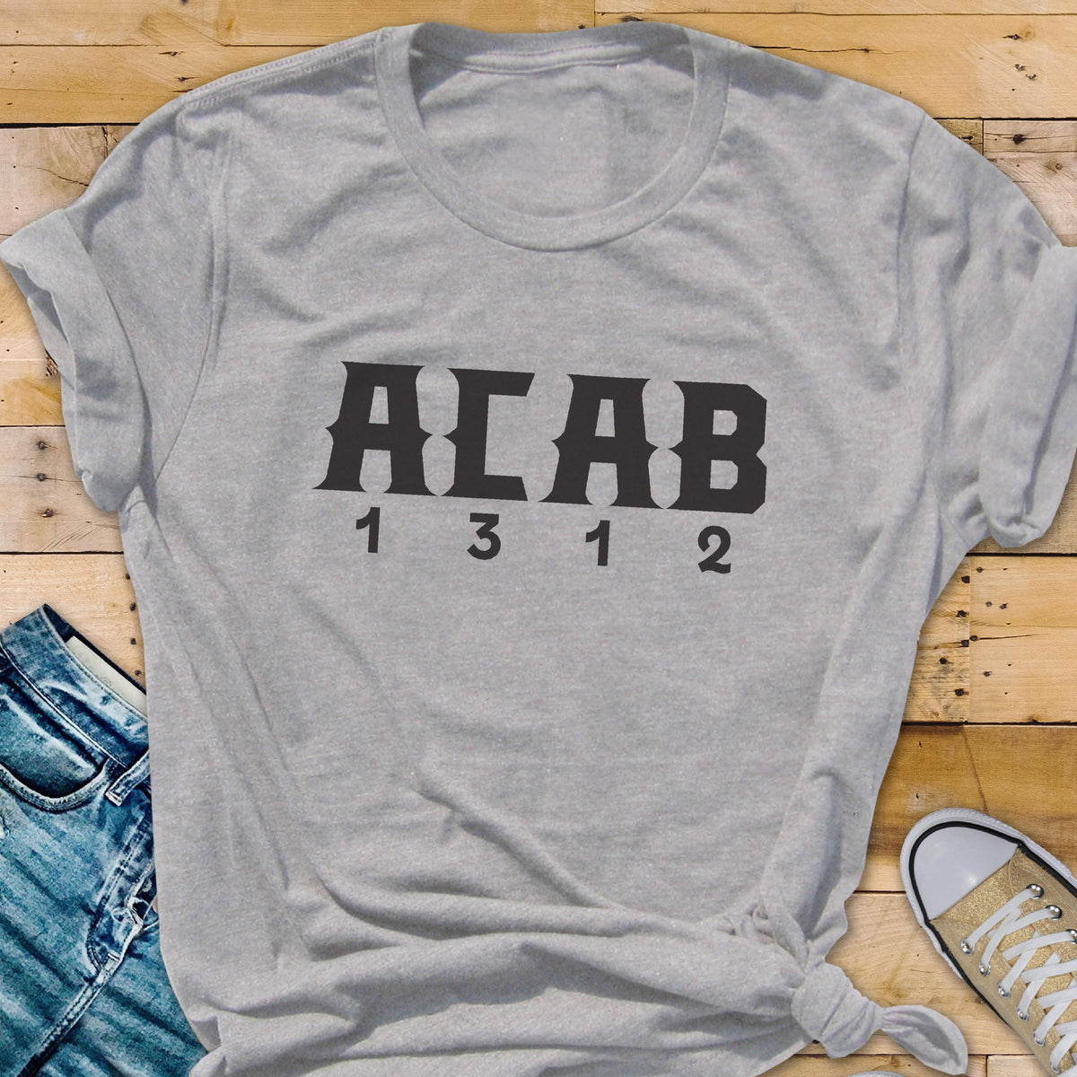 May include: Gray t-shirt with the text "ACAB 1312" printed in black.