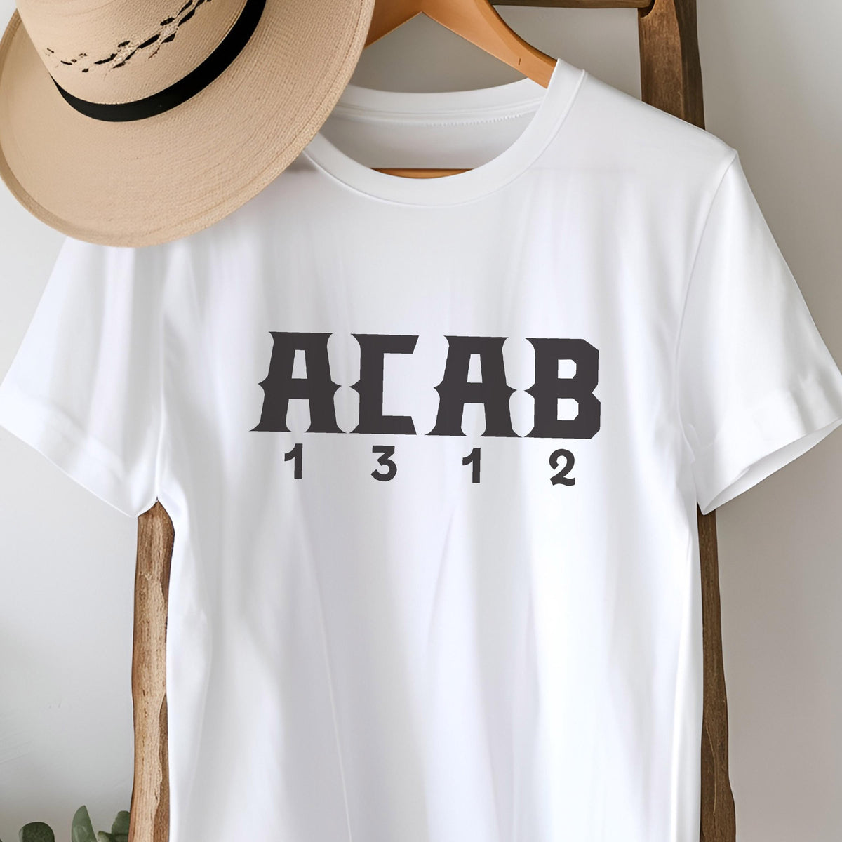 May include: White t-shirt with black text that reads "ACAB 1312".