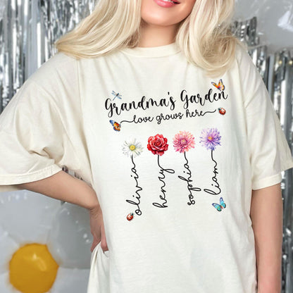 May include: A white t-shirt with the text "Grandma's Garden - love grows here" and four flowers with names Olivia, Henry, Sophia, and Liam written underneath.