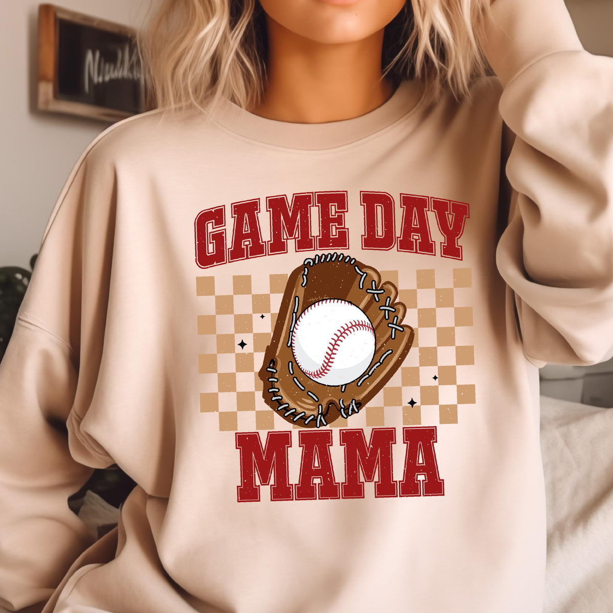 May include: A beige sweatshirt with the text "GAME DAY MAMA" in red letters. A baseball and glove are in the center of the text.