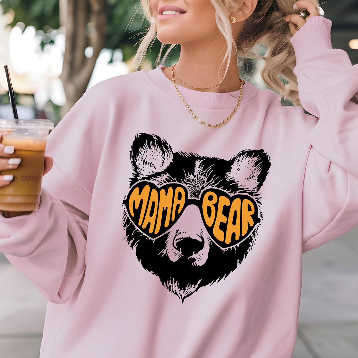 May include: Pink sweatshirt with a black bear wearing heart-shaped sunglasses that say "Mama Bear" in orange letters.