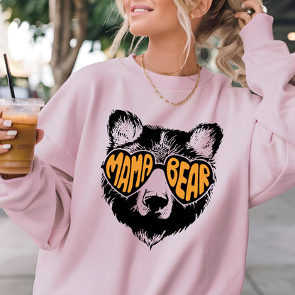 May include: Pink sweatshirt with a black bear wearing heart-shaped sunglasses that say "Mama Bear" in orange letters.